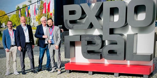 (v.l.n.r.) Steffen Blaser, Matthias Millow, Andreas Palla und John Frank neben dem Expo Real Logo