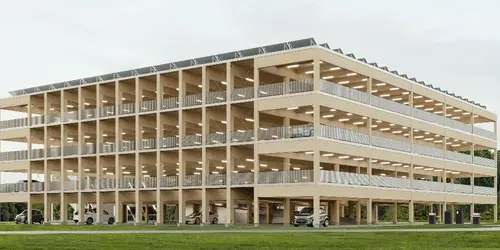komplettes Holz-Parkhaus in Jülich, Erstentwurf von fischerarchitekten Partnerschaft mbB, Aachen Mehrstöckiges Parkhaus aus Holz mit offenem Fassadendesign, umgeben von Wiesen und Bäumen.